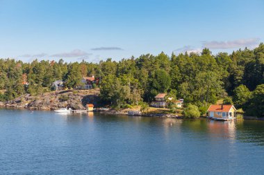 Stockholm Archipelago, view from the cruise ship. Cottages on the shore clipart