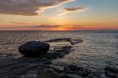 Baltık Denizi üzerinde gün batımı. Estonya 'nın kayalık kıyıları.