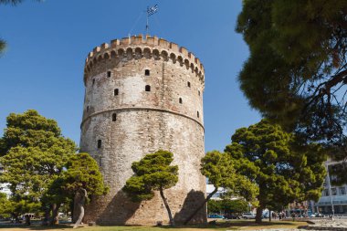 THESSALONIKI, GREECE - SEPTEMBER 10, 2018: The White Tower and greenery around clipart