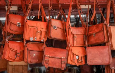 Close up view of several leather hand bags up for sale in street market , Jaipur, India.