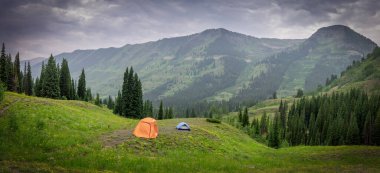 Panoramic view of Colorado landscape, Camping tent in the middle of rocky mountain wilderness, near Crested Butte. clipart