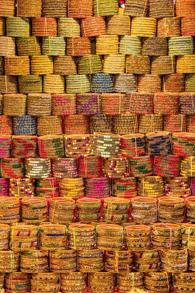 Stack of colorful bangles up for sale in India street market, selective focus.