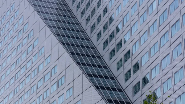 Exterior architecture of modern tall glass building in Rotterdam, Netherlands.
