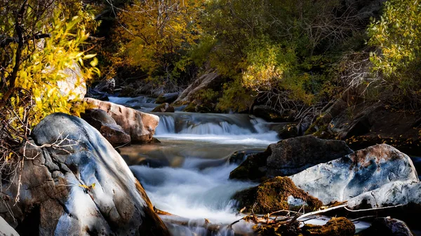 Water falls on Big Cottonwood creek in Utah during autumn time, long exposure shot.