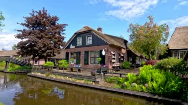 Hollanda 'nın ünlü Giethoorn köyünde geleneksel sazdan çatı evleri. Yolların olmadığı ve sadece ulaşım kanallarının olduğu bir yer..