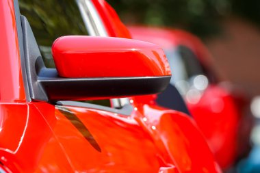 Side view mirror on red classic car