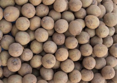 Pile of fresh Sapota fruits in the market in India. clipart