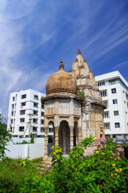 Historic hindu temple in the middle of apartment buildings in Visakhapatnam city, India clipart