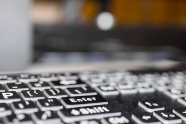 Close up view of key board in front of monitor, shallow depth of field. clipart