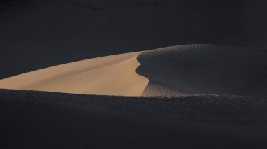 Mesquite Kum Tepeleri Ölüm Vadisi Ulusal Parkı, Kaliforniya 'da akşam güneşi altında.