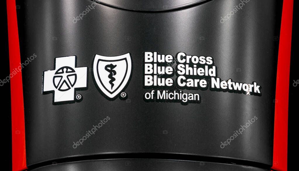 Detroit, Michigan, USA - January 16, 2025: Signage of Blue cross Blue shield, Blue care network on a formula 1 race car , is a non profit health care insurance company.