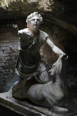 Statue of the god Mithras killing a bull in Ostia Antica. Rome, Italy clipart