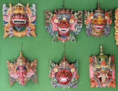 Geleneksel Bali maskesi bir market tezgahında oyulmuş ve boyanmış.