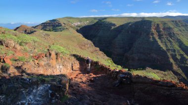 A panoramic hiking trail from Arure to La Merica overlooking the Valle Gran Rey, La Gomera, Canary Islands, Spain, with Arure village in the background and the plunging cliffs of the Valle Gran Rey