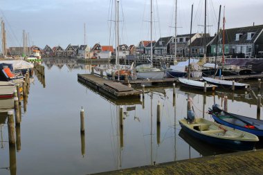 The harbor of Marken, a fishing village with traditional wooden houses and sailing boats, located in the North of Amsterdam, North Holland, Netherlands