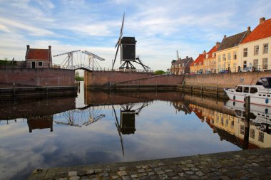 The old Harbor of Heusden, North Brabant, Netherlands, a fortified city located 19km far from Hertogenbosch, with a drawbridge and a windmill clipart