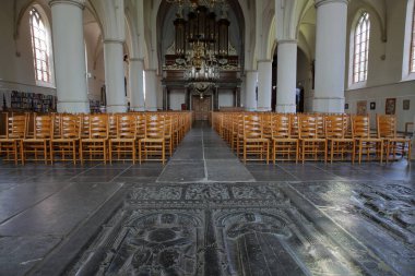 BOLSWARD, NETHERLANDS - 14 Temmuz 2023: Martinikerk (St Martin Kilisesi) ön planda mezar taşları, sütunlar ve arka planda org