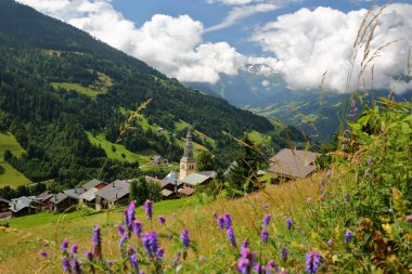 The village Hauteluce, Beaufortain, Savoie, France, a ski resort surrounded by mountain pastures and mountains clipart