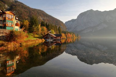 Colorful Autumn scenery and reflections on the lake Altausseer See in Altaussee, Bad Aussee, Salzkammergut, Styria, Austria, Europe, with the Trisselwand mountain in the background clipart