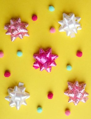 Sarı arka planda renkli bir hediye. Düz yatış, üst görünüm.