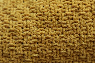Arka plan olarak sarı örülmüş doku, yakın plan. Tekstil deseni