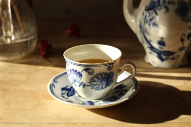 Cup of tea on a wooden table. Selective focus. clipart