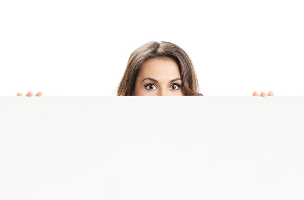 Young woman with blank signboard or copyspace for slogan or text, isolated over white background