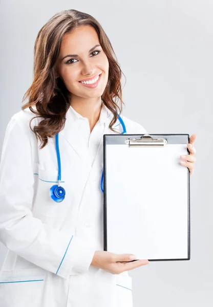 Happy Smiling Young Female Doctor Showing Blank Clipboard Copyspace Grey — Stock Photo, Image