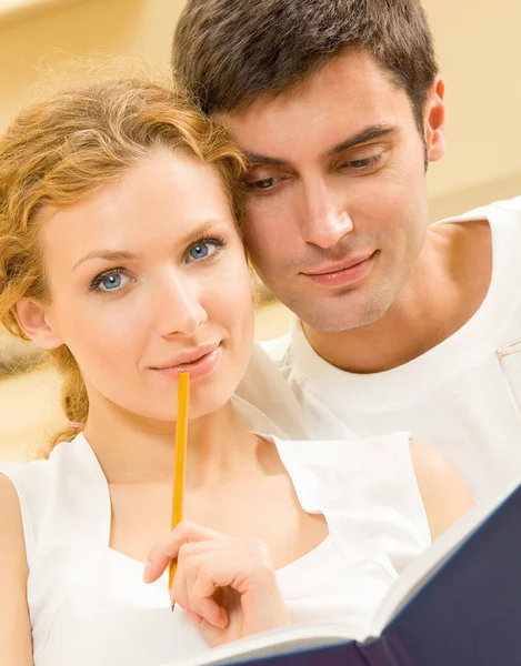Cheerful Smiling Young Couple Organizer Planning Indoors — Stock Photo, Image
