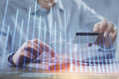 Ellerinde kredi kartı ve forex çizimi olan bir adamın çift pozu. İnternet E-ticaret kavramında hisse senedi ve dijital fintech.