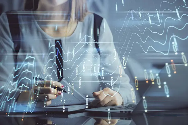 stock image Double exposure of businesswoman hands typing on computer and financial graph hologram drawing. Stock market analysis concept.