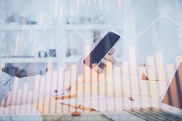 stock image Double exposure of man's hands holding and using a digital device and forex graph drawing. Financial market concept.