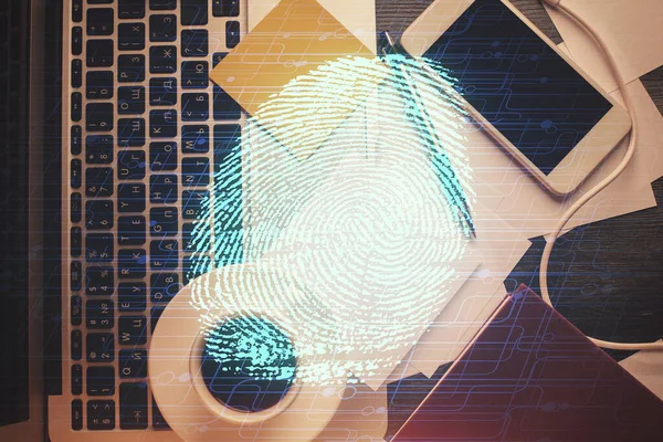 Finger print over computer on the desktop background. Top view. Double exposure. Concept of securitization.