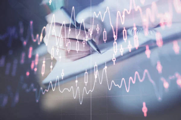 stock image Financial forex graph displayed on hands taking notes background. Concept of research. Double exposure