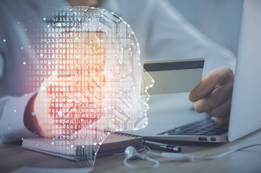 Kredi kartı ve beyin temalı çizimlerle bilgisayarda yazarken çift pozlama. E-ticaret ve yapay zeka kavramı.