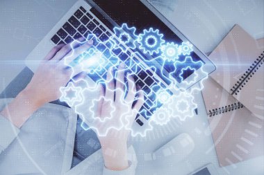 Bilgisayar ve finansal temalı hologram çizimleri üzerinde çalışan kadın elleri çift pozlama. Üst Manzara. İş konsepti.