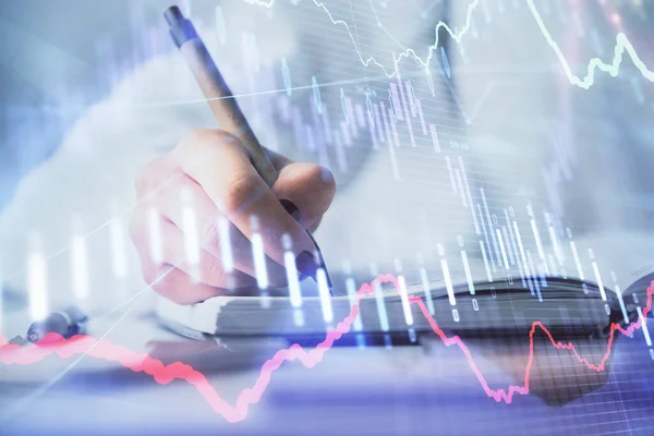 Multi exposure of woman\'s hands making notes with forex graph hologram. Concept stock market analysis.