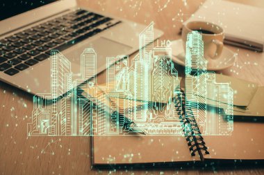 Masa arkasında kahve ve eşyalar olan iki kat bina çizimi ve masaüstü görüntüsü. Akıllı şehir kavramı