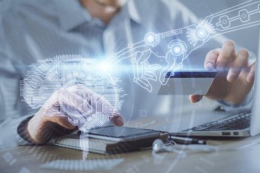 Kredi kartı ve beyin temalı çizimlerle bilgisayarda yazarken çift pozlama. E-ticaret ve yapay zeka kavramı.