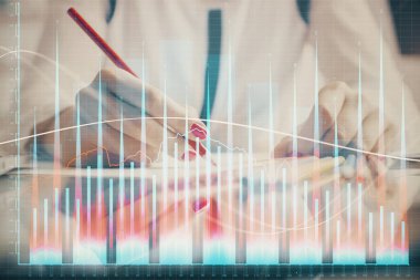 Bir kadın eller Not defteri hisse senedi piyasası hakkında bilgi yazma. Ön Forex grafik hologramlar. Araştırma konsepti.