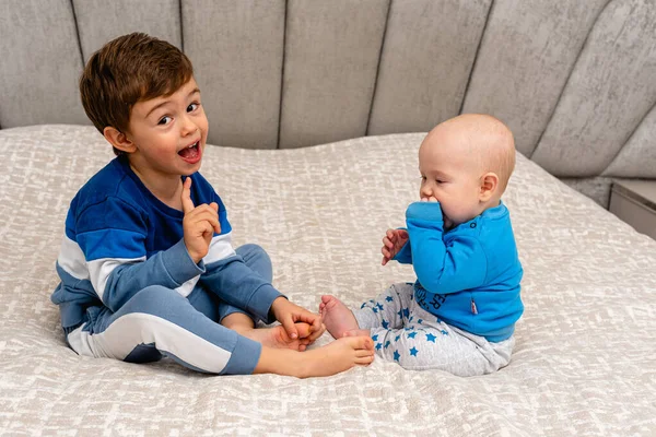 stock image Two small boys sitting together in a bright crib. Have fun The concept of small children