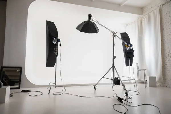 interior of a photo studio with modern devices. Empty photo studio with lighting equipment