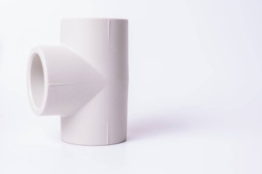 light PVC pipe tee connection for water isolated on light background close up.