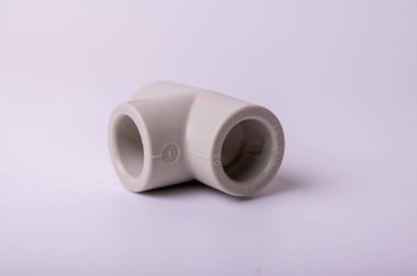 light gray PVC pipe tee connection for water isolated on light background close-up. side view, top view