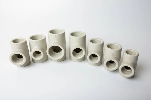 stock image light gray PVC pipe tees for water, various types and diameters, isolated on a light background close-up. side view, top view
