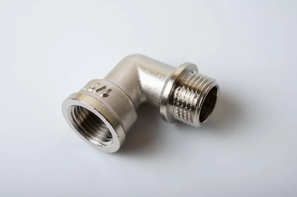 Stock image brass metal tee water adapters isolated on light background close up plumbing connections and details