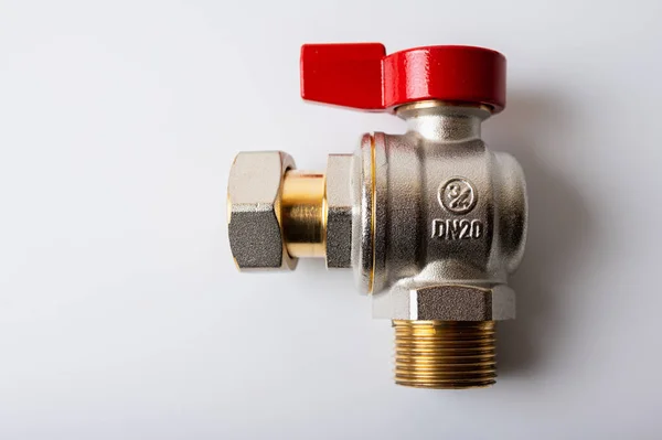 stock image brass metal water faucet with red valve, different angle isolated on light background close up, plumbing connection