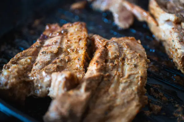 stock image BBQ pork ribs pork loin cut with hot honey chili marinade charred close-up on gray surface