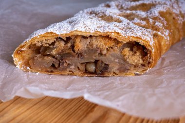 Elma ve tarçınla doldurulmuş lezzetli meyveli turta parçaları hafif bir arka planda hafif bir tabakta. Yazmak için yer var. Manzarayı kapat. Ev yapımı Ukrayna hamur işleri