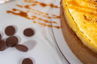 Kabuklu peynirli kek, bir parça kesilmiş, hafif bir tabakta, arka planda. Pasta, hamur işi.